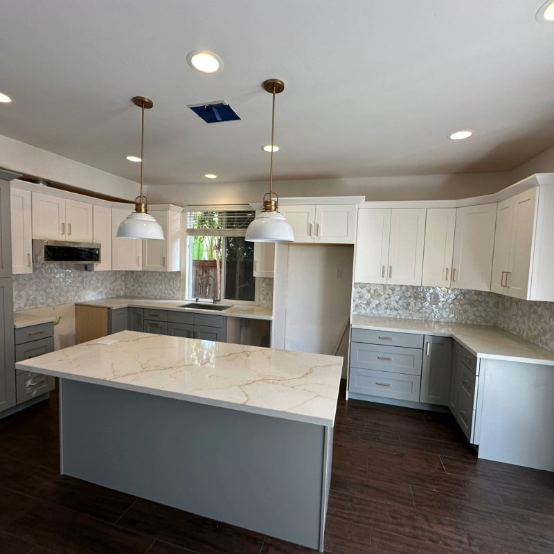 European style kitchen remodel in Carlsbad by ASAP Remodeling featuring white cabinets and quartz countertops